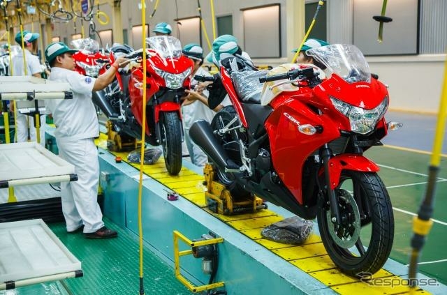 The dream come true : motorcycles assembled on a mass production line at Honda Thailand.