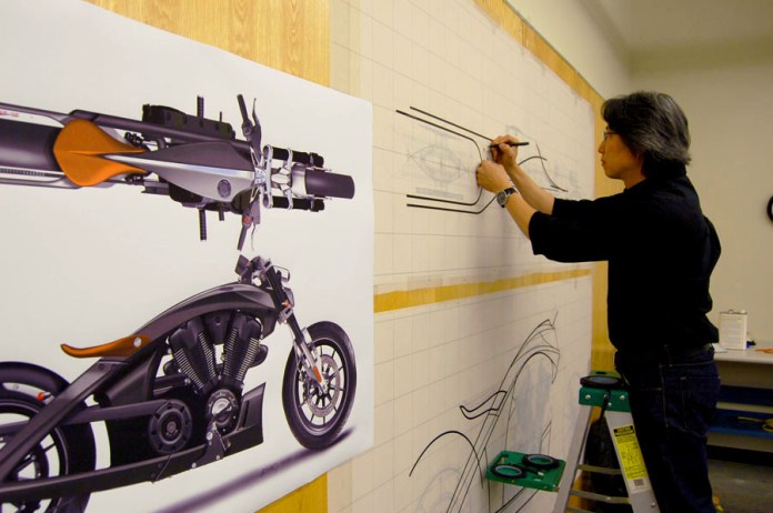 Polaris designer Michael Song works on a full size "tape" drawing of the Victory Core concept. Photo : Polaris