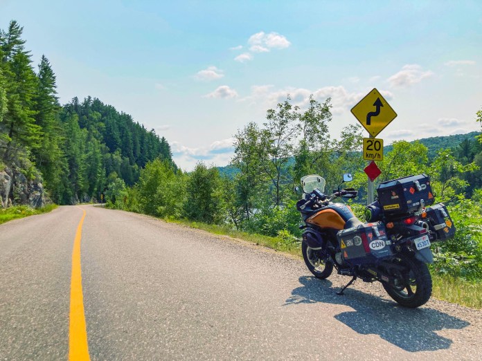 Multiple turn warning and slow speed warning signs on Highway 129 in Ontario
