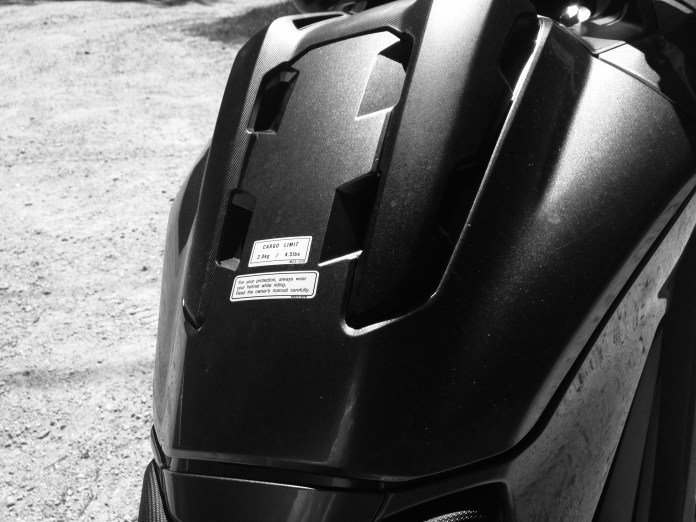 Cargo storage in the "tank" space also integrates bungee hook points for a tank bag. Fuel is under passenger seat.